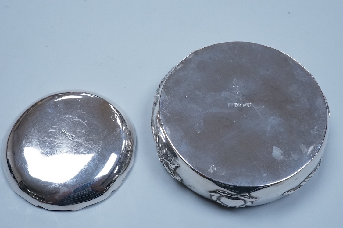 An early 20th century Chinese Export white metal small trinket dish with dragon decoration, by Sing Fat, diameter 66mm, together with a larger Chinese Export white metal trinket dish, maker Tien Shing?.